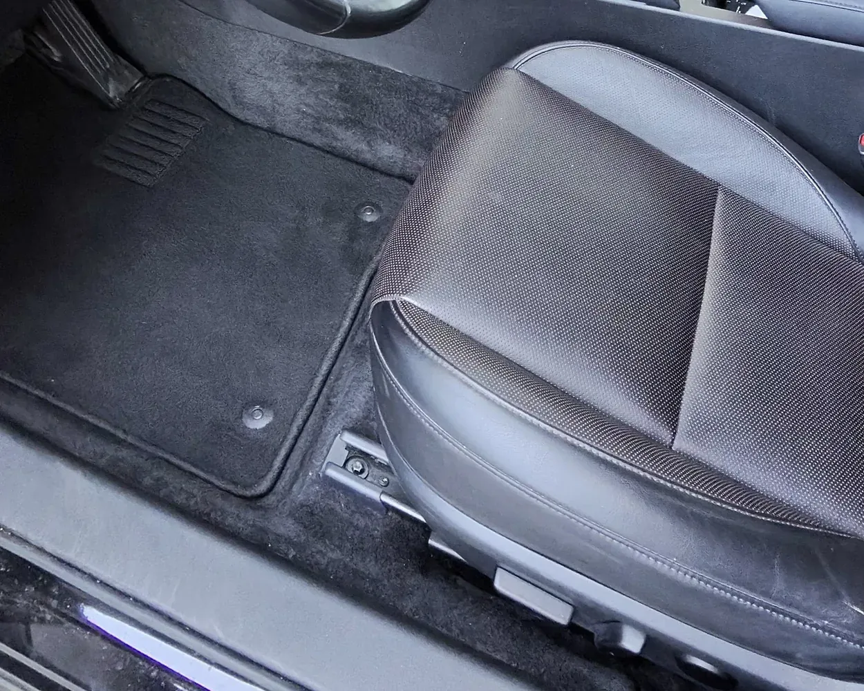 The same footwell and seat after the interior detail, clean, with the mat back in place