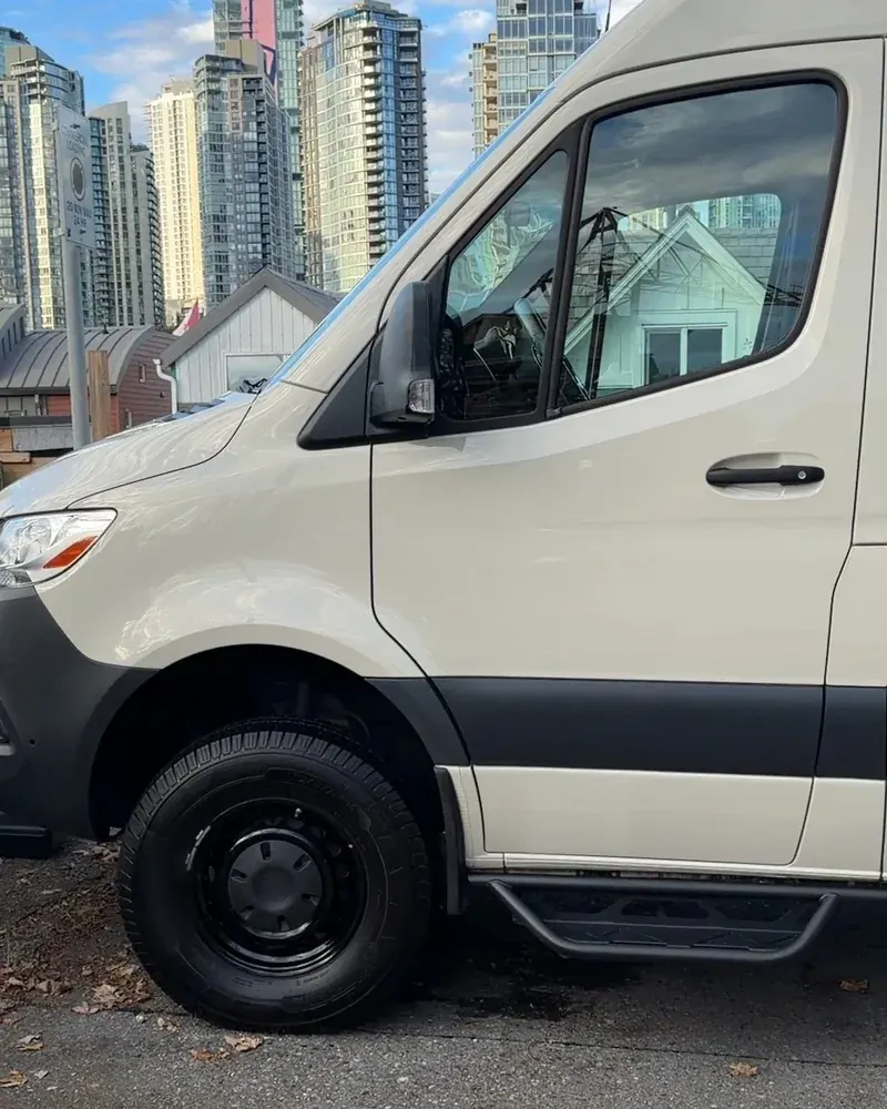 A camper van after the detail, Vancouver towers behind it