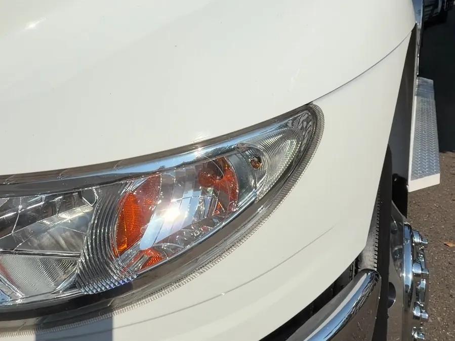 A clear truck headlight and glossy white paint